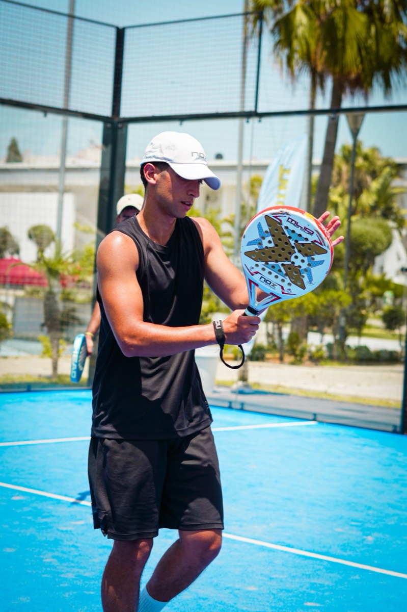 Padel player hitting a forehand