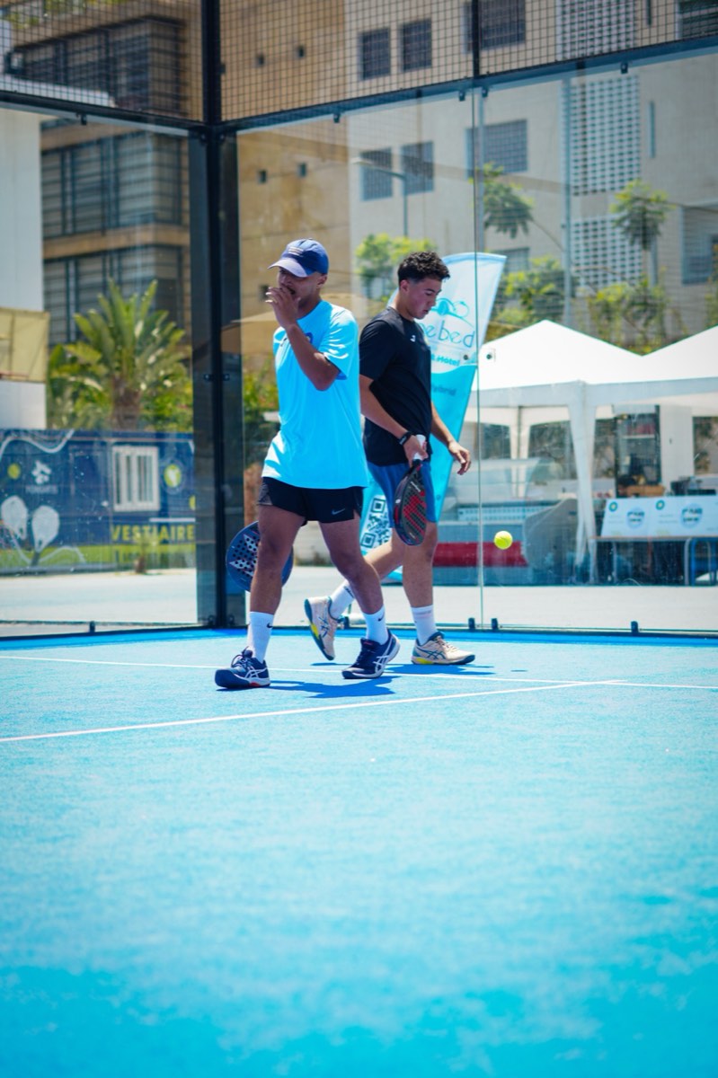 Padel player serving